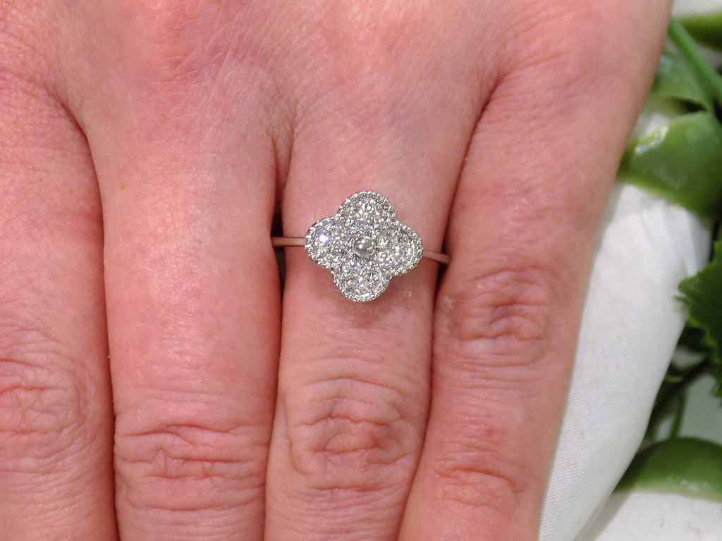 This is a Natural Diamond Van Cleef Style White Gold Ring on a ladies finger.