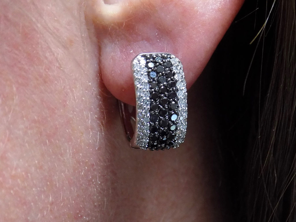 1.00ct total weight natural black and white diamond earrings in solid 14K white gold in a ladies ear.
