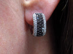 1.00ct total weight natural black and white diamond earrings in solid 14K white gold in a ladies ear.