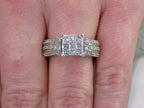 This is an Estate ring with 1.00ct total weight invisible set diamond ring with natural princess cut and round diamonds in white gold on a ladies finger.