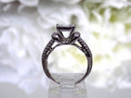This is a side view of an Estate ring with 1.00ct total weight invisible set diamond ring with natural princess cut and round diamonds in white gold.