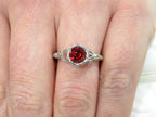This is a 1.00ct natural garnet ring in a filigree Victorian style in 10K white gold on a ladies finger.