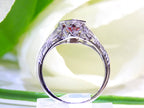 This is a 1.00ct natural garnet ring in a filigree Victorian style in 10K white gold side view with a white and green background.