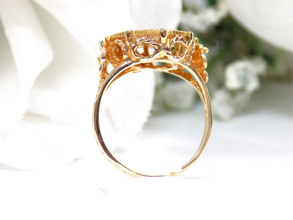 This is a side view of a women's US $1 gold coin ring dated 1853 and set in 14K yellow gold in great condition shown with a white background.