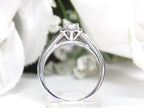 This is a side view halo style .50ct total weight natural princess cut diamond ring in white gold with white background.