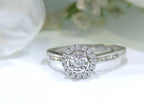 Ladies' halo style small round diamond ring in white gold.