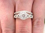 This is a women's 2-piece wedding set which includes the engagement ring and matching band weighing 1.02ct in natural diamonds in white gold with rose gold accents shown on a woman's finger