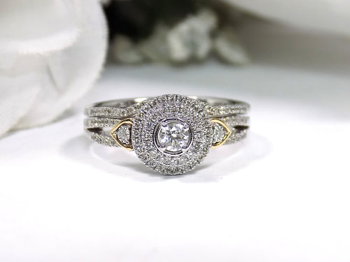 This is a halo style 2-piece wedding set ring with matching band in white gold with yellow gold accents on a white background.
