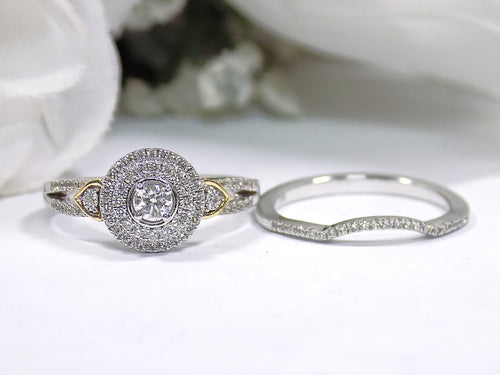 2 rings engagement ring and matching band halo style in diamonds and white gold sitting side by side on white background.
