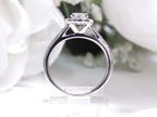 Halo style natural diamond ring in white gold with white background shown from the side.