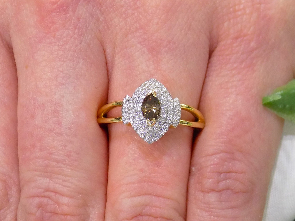 .50ct total weight with chocolate marquise center diamond and white round diamond accents in 2-tone white and yellow gold on a ladies finger.