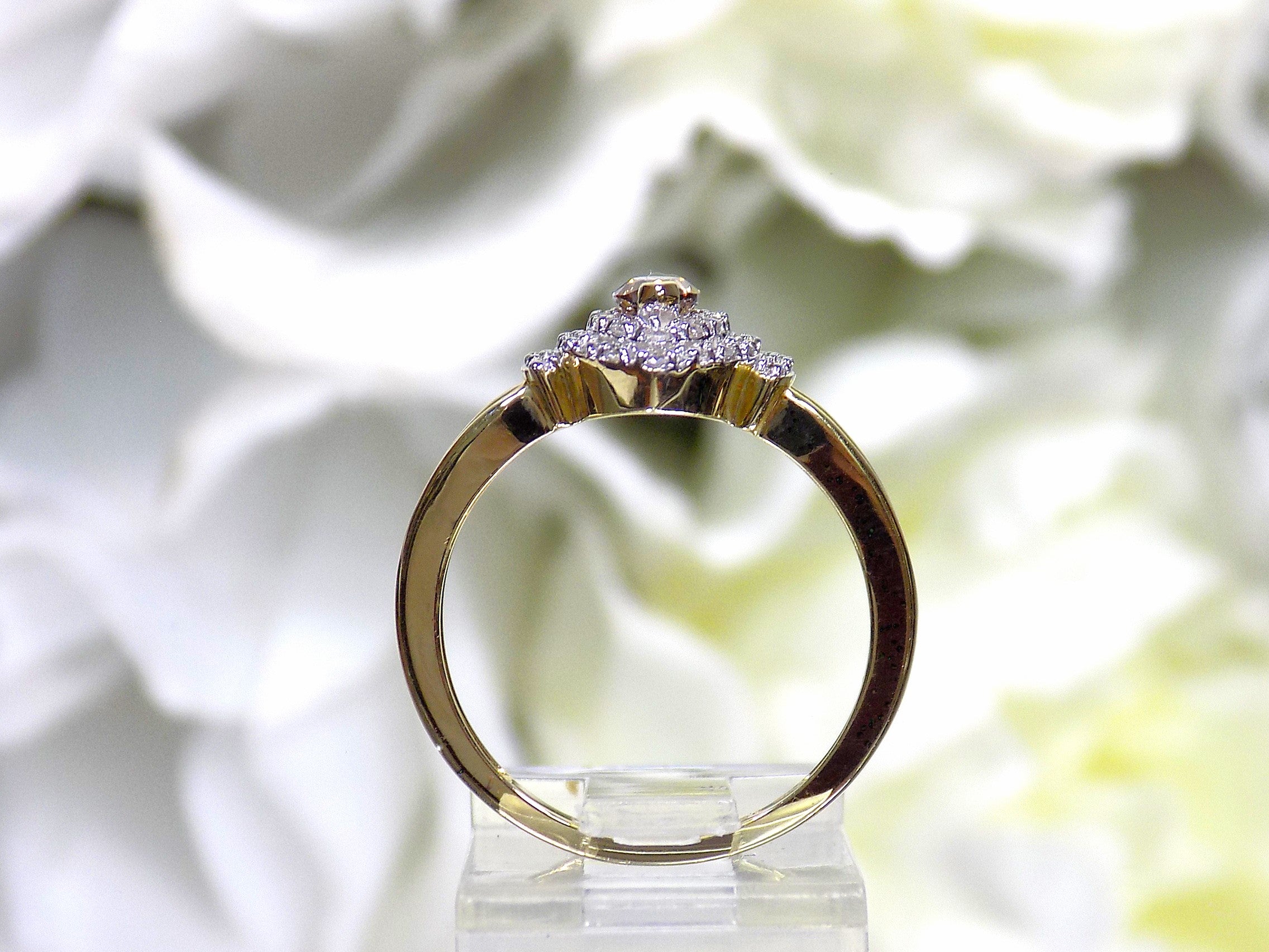 .50ct total weight with chocolate marquise center diamond and white round diamond accents in 2-tone white and yellow gold. Side view.