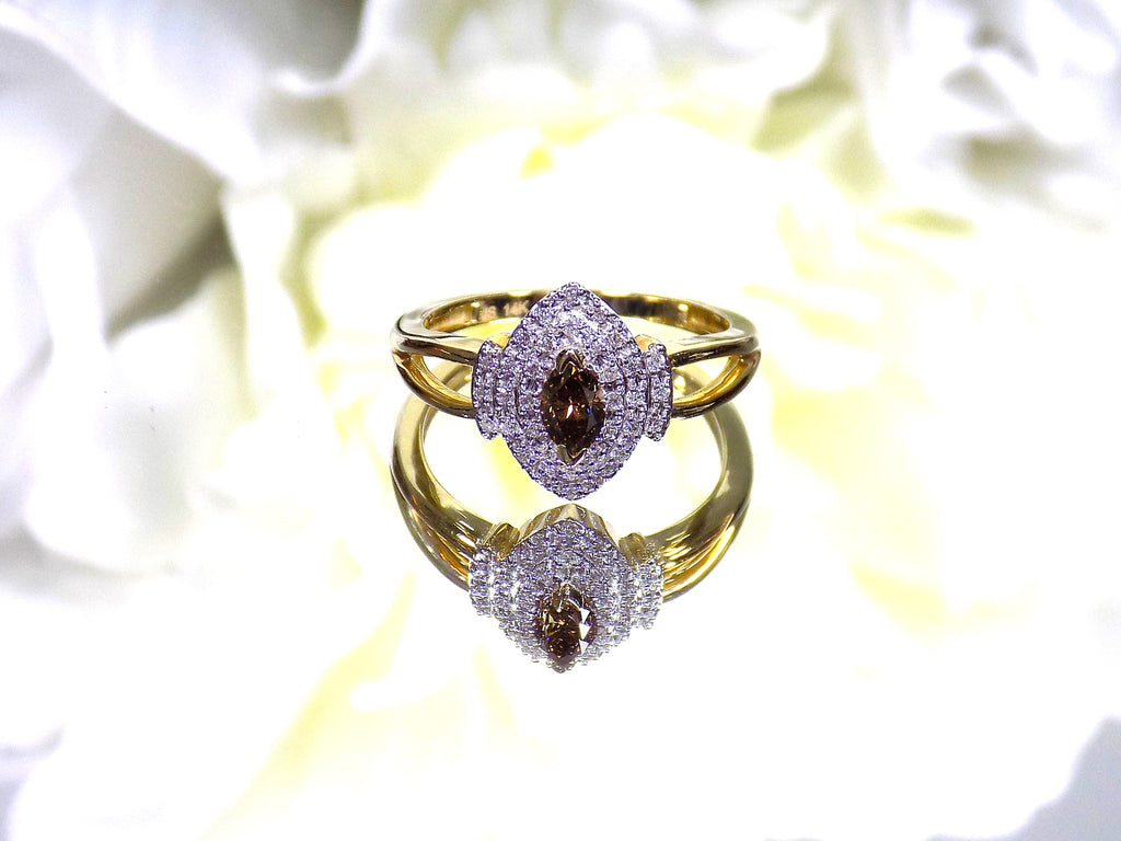 .50ct total weight with chocolate marquise center diamond and white round diamond accents in 2-tone white and yellow gold.
