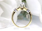 This is a side view of a .80ct total weight natural diamond ring baguette diamond accents in 2-tone 18K yellow gold and platinum shown with a white background.