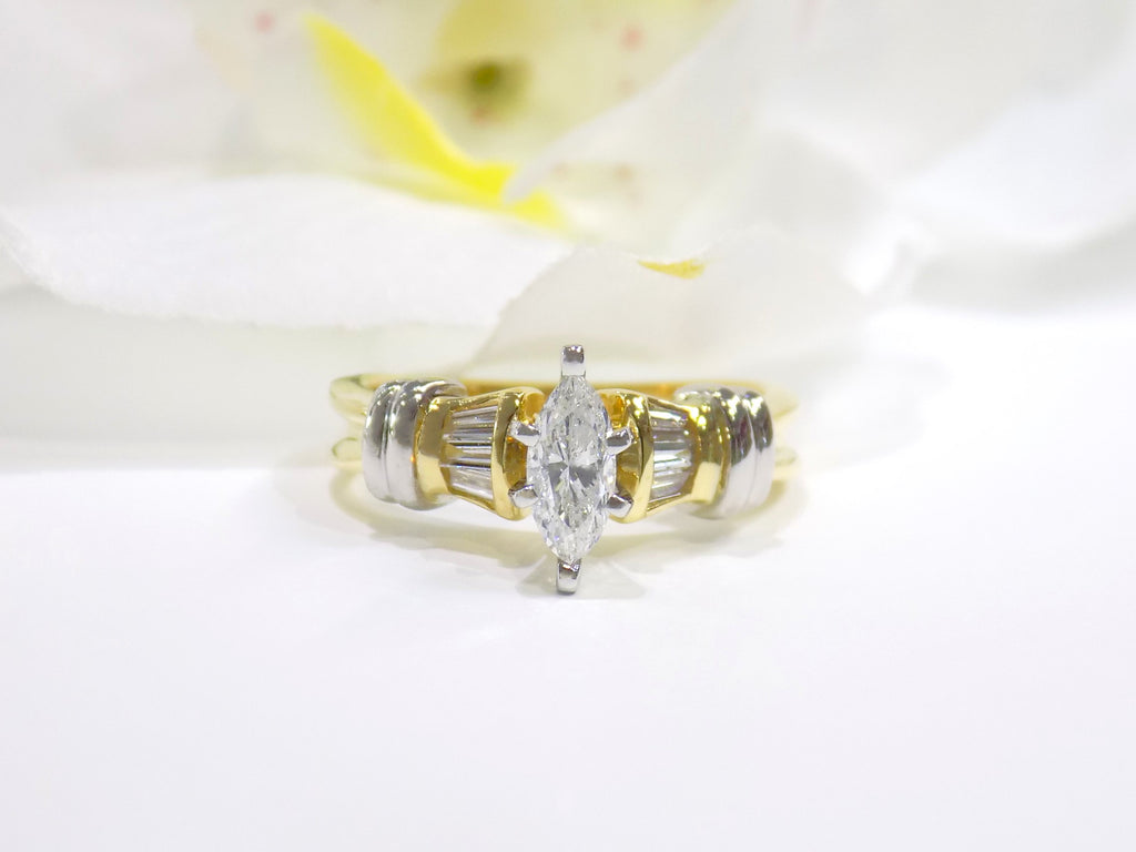 This is a .80ct total weight natural diamond ring baguette diamond accents in 2-tone 18K yellow gold and platinum shown with a white background.
