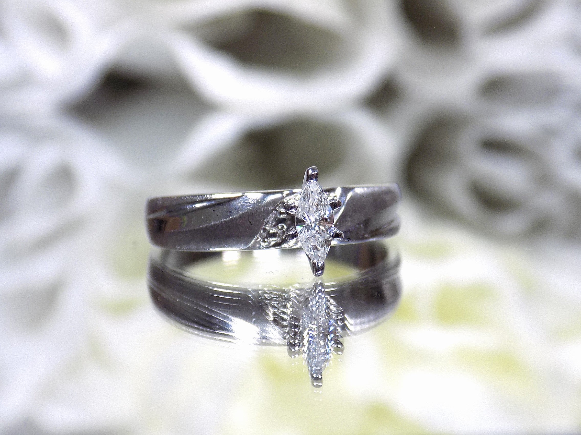 Preowned white gold ladies small marquise shape diamond ring.