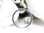 This is a side view of the matching band what goes with a natural oval shape diamond engagement ring with a white background.