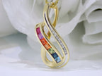 This is a women's slide pendant with 1.38ct total weight natural multicolor natural sapphires and .12ct total weight natural round diamonds in 14K yellow gold with a white floral background.