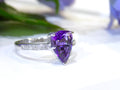 This is a 2.00ct natural amethyst and .06ct diamond ring in 14K white gold with a white and green background.