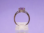 This is a 2.00ct natural amethyst and .06ct diamond ring in 14K white gold with a purple background.