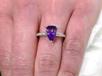 This is a 2.00ct natural amethyst and .06ct diamond ring in 14K white gold on a womans finger.