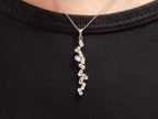 This is a custom made .91ct natural baguette diamond necklace in 18K white gold on a ladies neck with a black shirt.