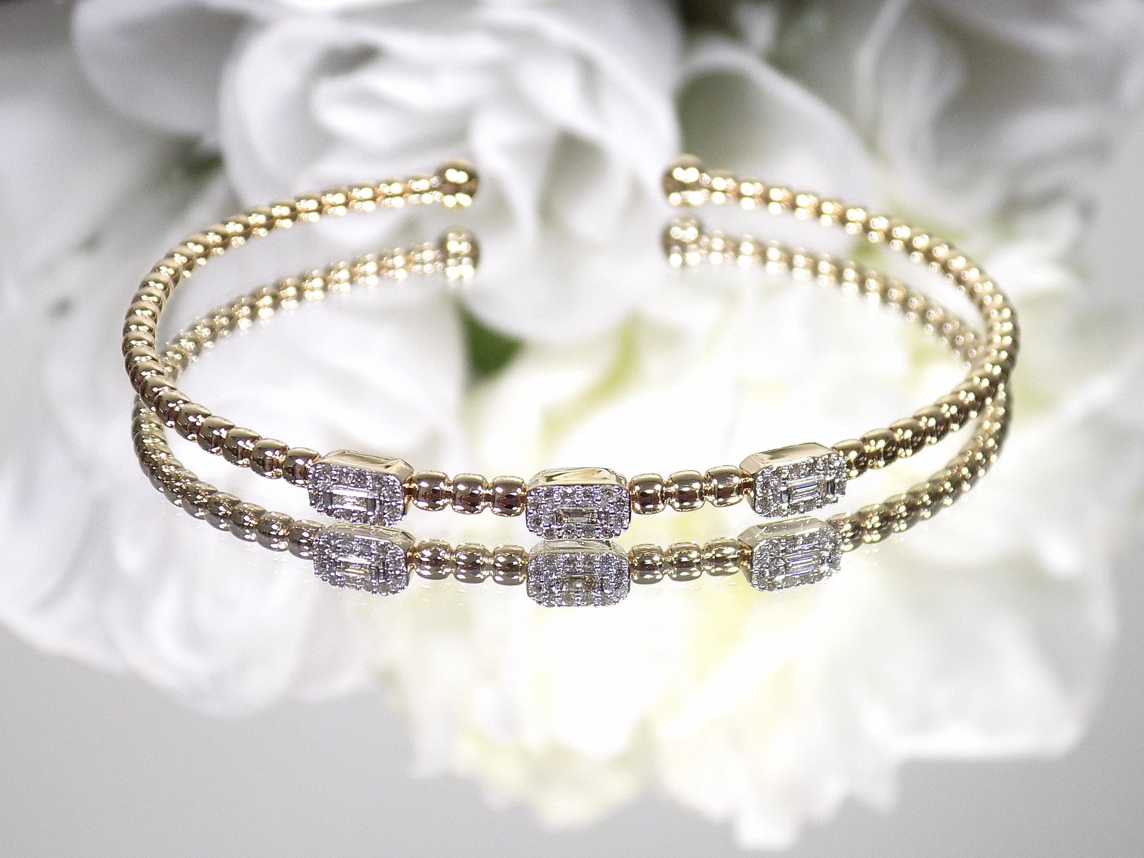 .25ct natural emerald cut and round diamond flex bracelet in 10K yellow gold.