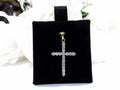 This is a .50ct natural diamond cross pendant in 14K white and yellow gold on a black pad with a white floral background.