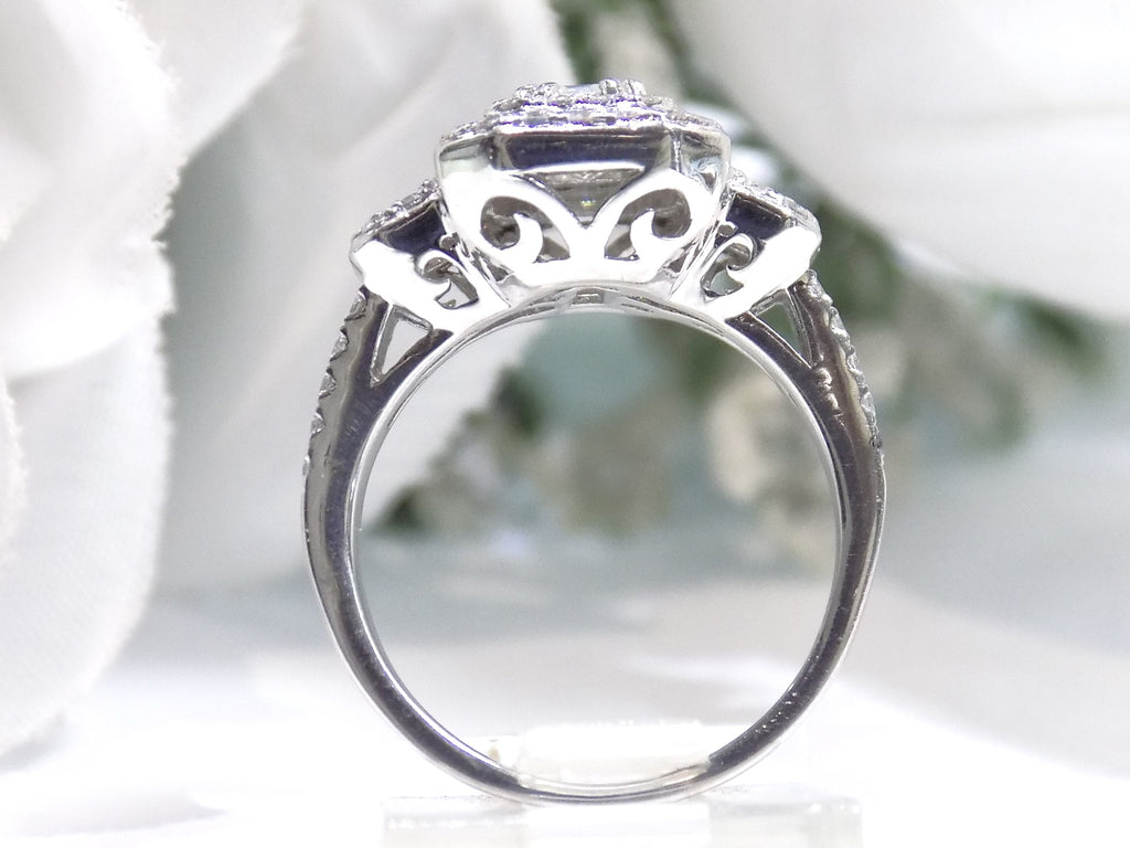 This is a side view of a 1.56ct total weight natural emerald cut and round diamond ring in platinum shown with a white background.