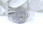 This is 1.56ct total weight natural emerald cut and round diamond ring in platinum shown with a white background.