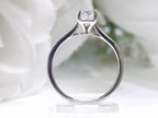This is a side view of women's 1.00ct natural radiant cut diamond solitaire ring in white gold with a white background.