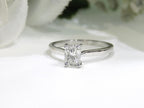 This is a women's 1.00ct natural radiant cut diamond solitaire ring in white gold with a white background.