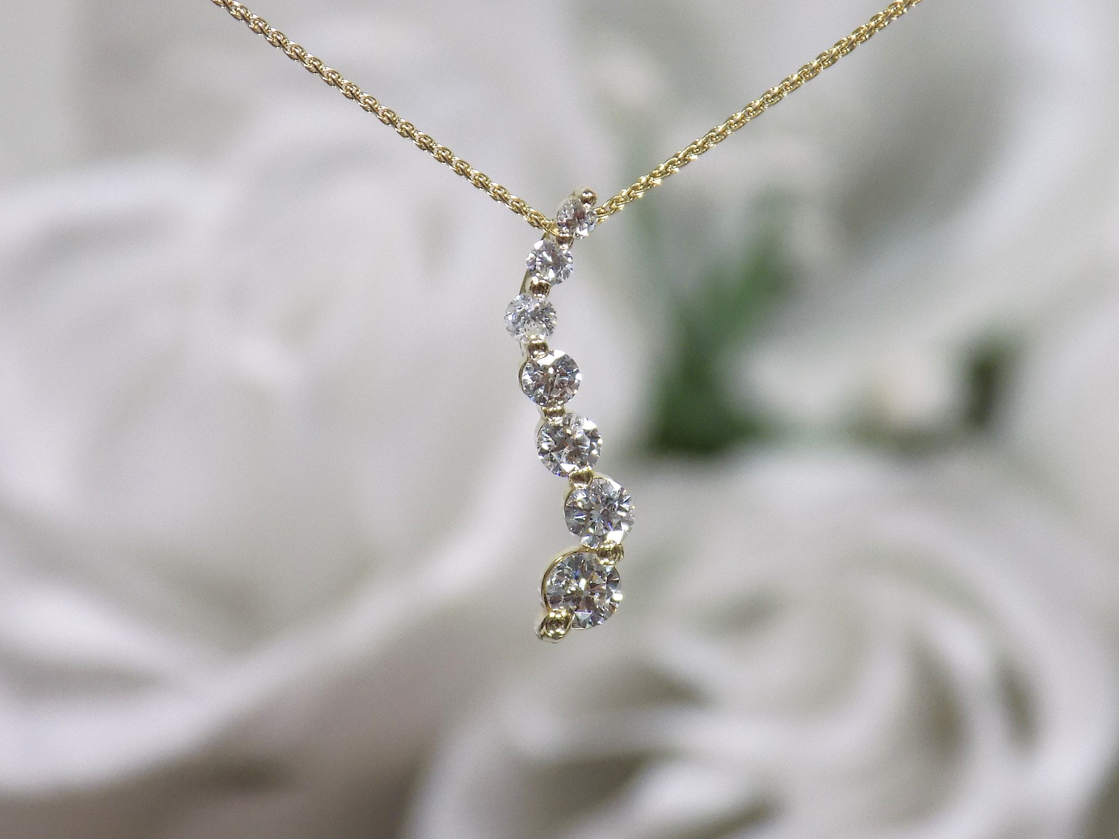 This is a vintage natural diamond journey style necklace in yellow gold.