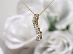 This is a side view of a vintage natural diamond journey style necklace in yellow gold.
