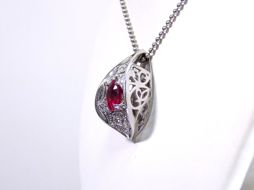This is a vintage Victorian style women's oval (pigeon blood) natural 1.05ct ruby with .15ct natural round diamond accents in platinum on a white neck side view.