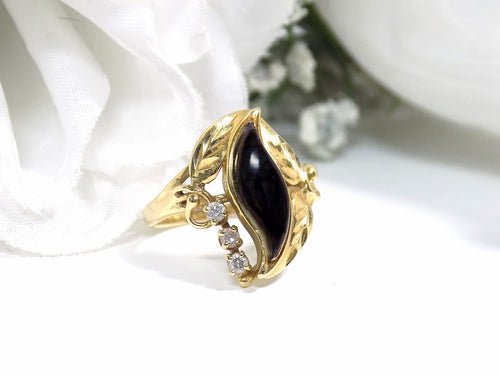 This is a genuine black onyx and diamond ring in yellow gold from our estate collection in like NEW condition on a white background.