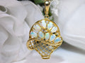 The is a genuine oval shape opal basket pendant in yellow gold from our estate collection in like new condition with white background.