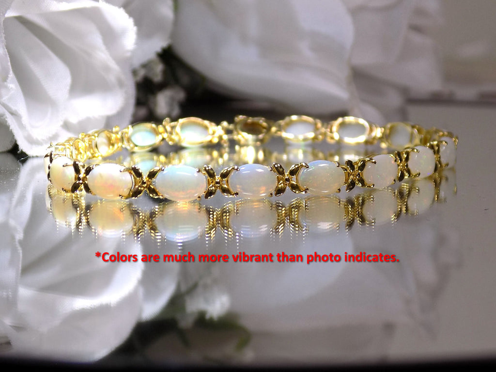 This is a genuine opal tennis bracelet in yellow gold from our estate collection in like new condition on white background.