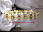 This is a genuine opal tennis bracelet in yellow gold from our estate collection in like new condition on white background.