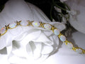 This is a genuine opal tennis bracelet in yellow gold from our estate collection in like new condition on white background.