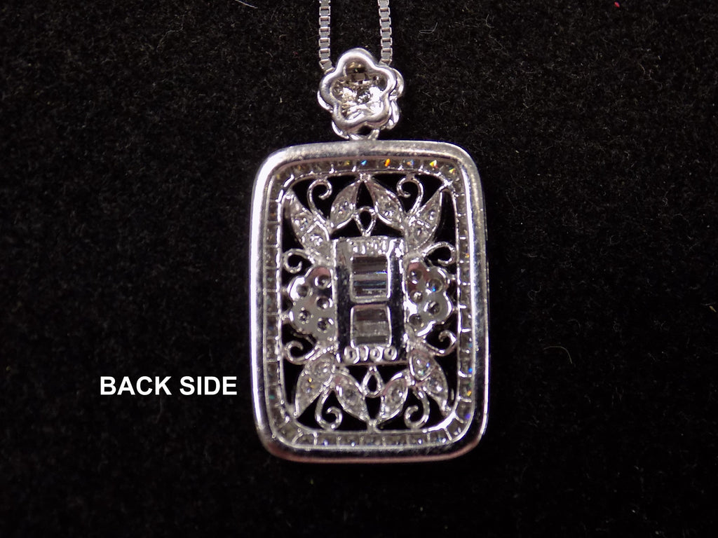This is a Victorian style pendant with 1.00ct total weight round and baguette diamonds set in 900 platinum view of the back of the pendant on a black background.