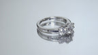 This is a video of a 3-stone style natural .90ct total weight round diamond ring in white gold turning slowly on a mirrored backgound.