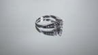This is a marquise shape diamond ring with round diamond accents in white gold turning slowly on a mirrored background.