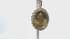 This is a video of a vintage 1987 Australian $200 gold coin with a yellow gold rope and diamond bezel pendant shown rotating with a white background.