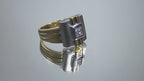 This is a woman's vintage art-deco ring that is two-tone with a brushed 18K yellow and white gold finish with .20ct total diamond weight rotating on a mirrored surface in a video