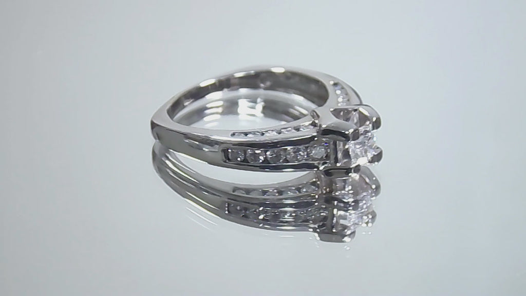 This is a video of a 1ct total weight natural round diamond ring in white gold shown turning slowly on a mirrored background.