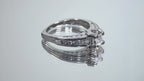 This is a video of a 1ct total weight natural round diamond ring in white gold shown turning slowly on a mirrored background.