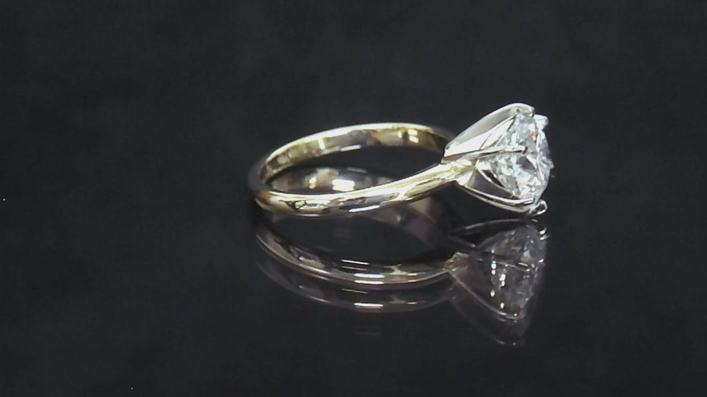 This is a video of a 2.20ct natural round brilliant diamond solitaire in yellow gold turning slowly on a black mirrored background.