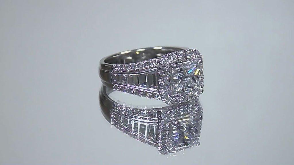 This is video of a 3.68ct total weight natural diamond ring with a 2.05ct natural princess cut set in a legendary designer Simon G white gold mounting shown rotating on mirrored background.
