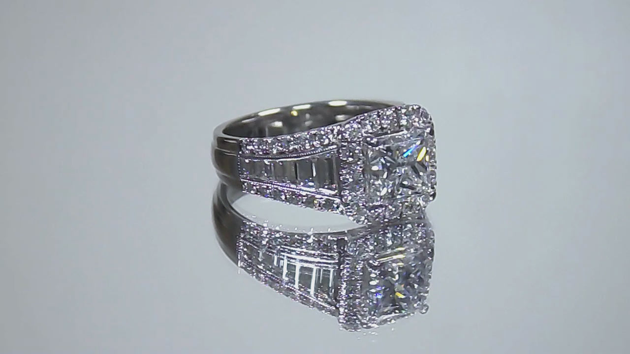 This is video of a 3.68ct total weight natural diamond ring with a 2.05ct natural princess cut set in a legendary designer Simon G white gold mounting shown rotating on mirrored background.